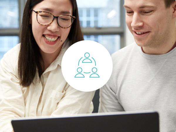 A smiling couple looking at a laptop screen