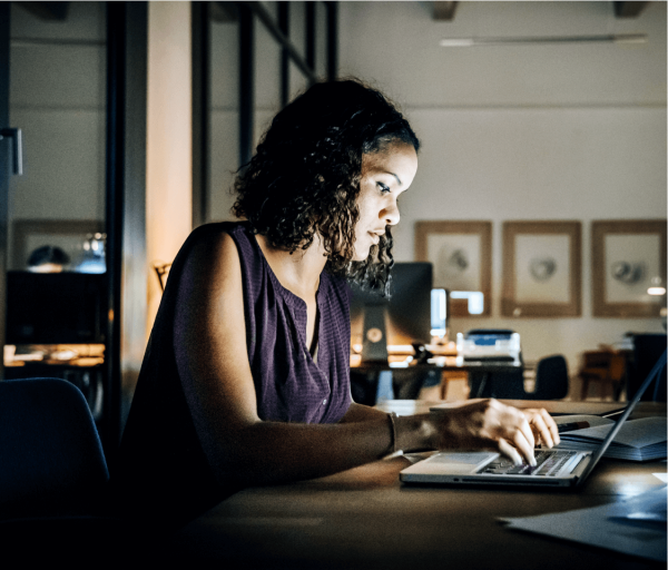 Developer seated at table working on a laptop